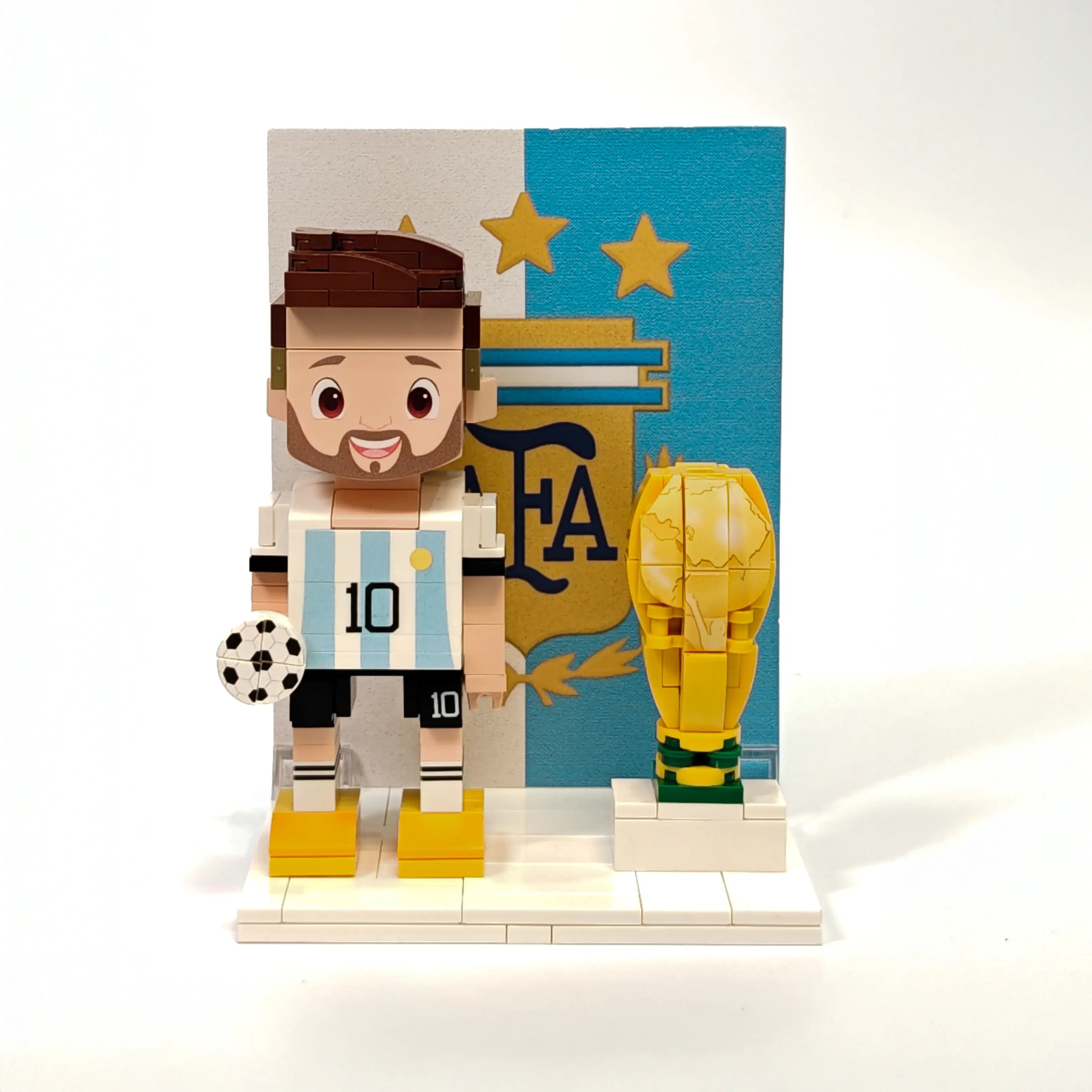 Popal Messi brick figurine wearing Argentina jersey, standing next to a World Cup trophy — football figurine