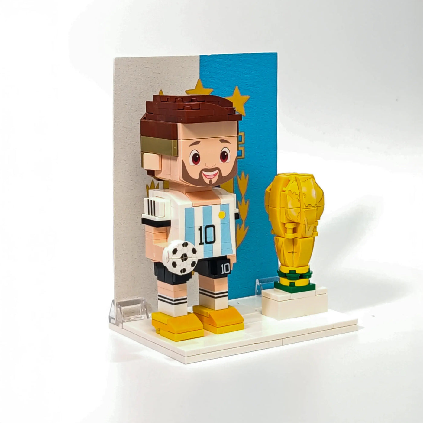 Right side of Popal Messi brick figurine wearing Argentina jersey, standing next to a World Cup trophy — collectible football minifig celebrating Argentina’s victory.