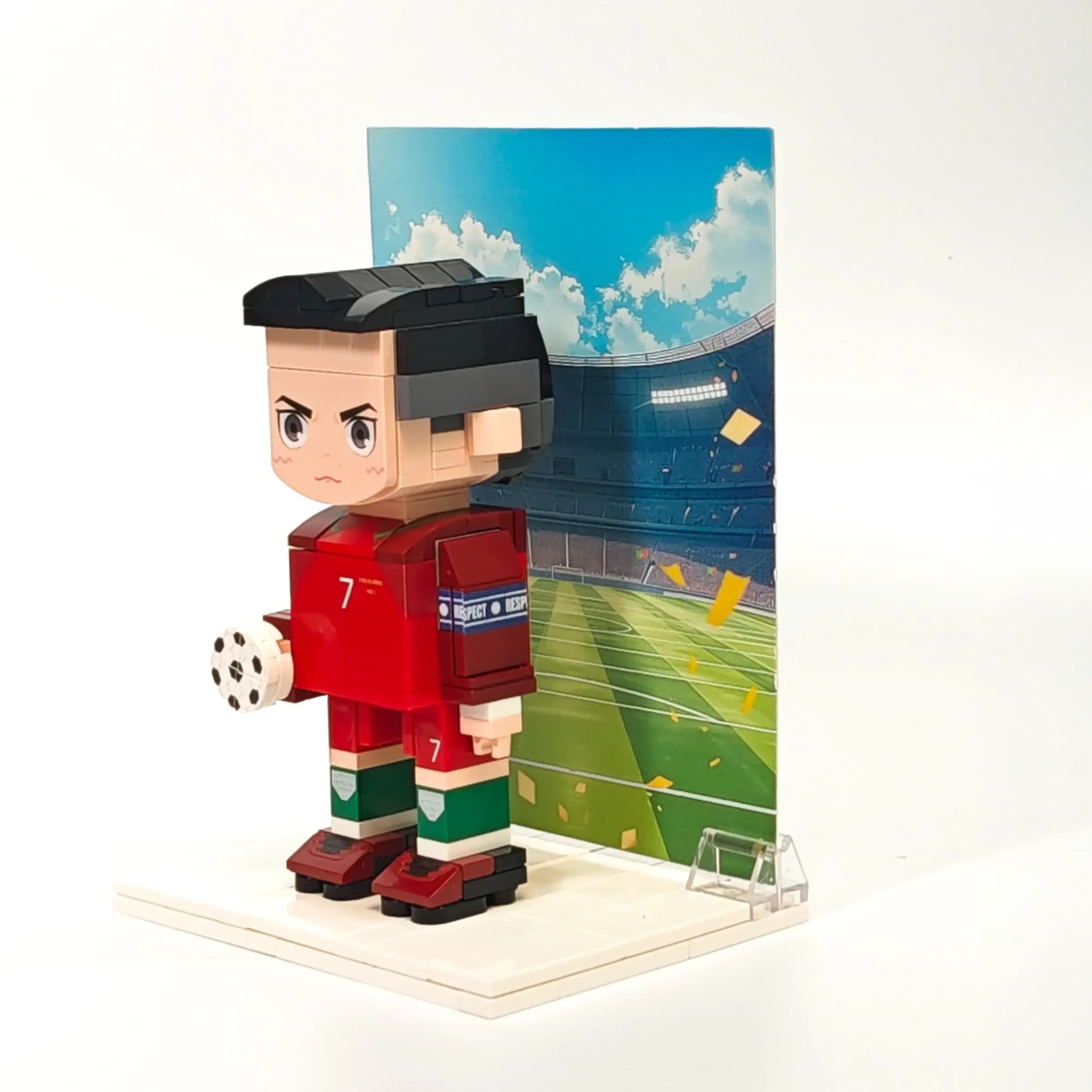 Left-side view of Ronaldo Popal figure in Portugal jersey, gripping a soccer ball — football toy